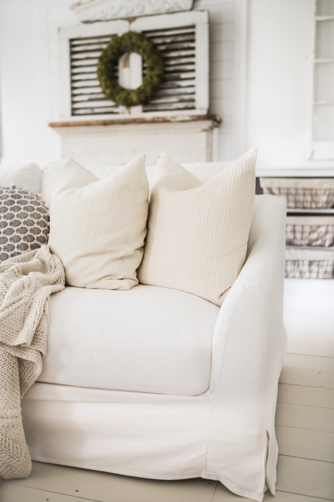 Simple Linen Slipcover from Bemz in front of a farmhouse fireplace