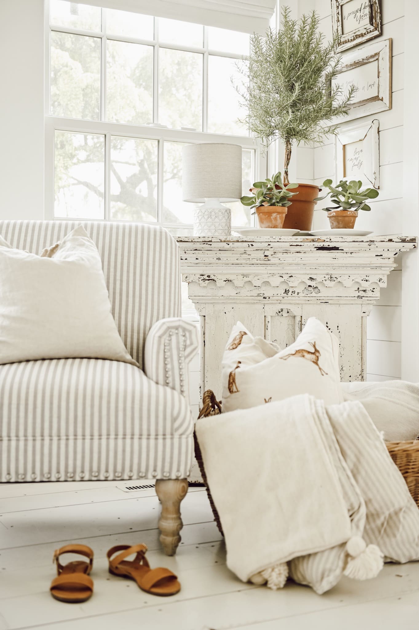 A cozy chair with extra cozy throws next to it. 