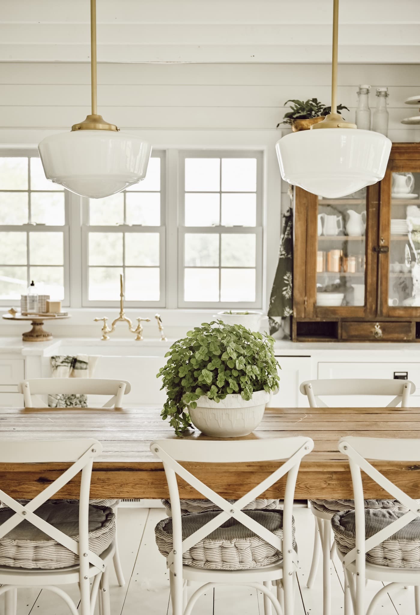 Outdoor chairs brought inside next to dining table kitchen island