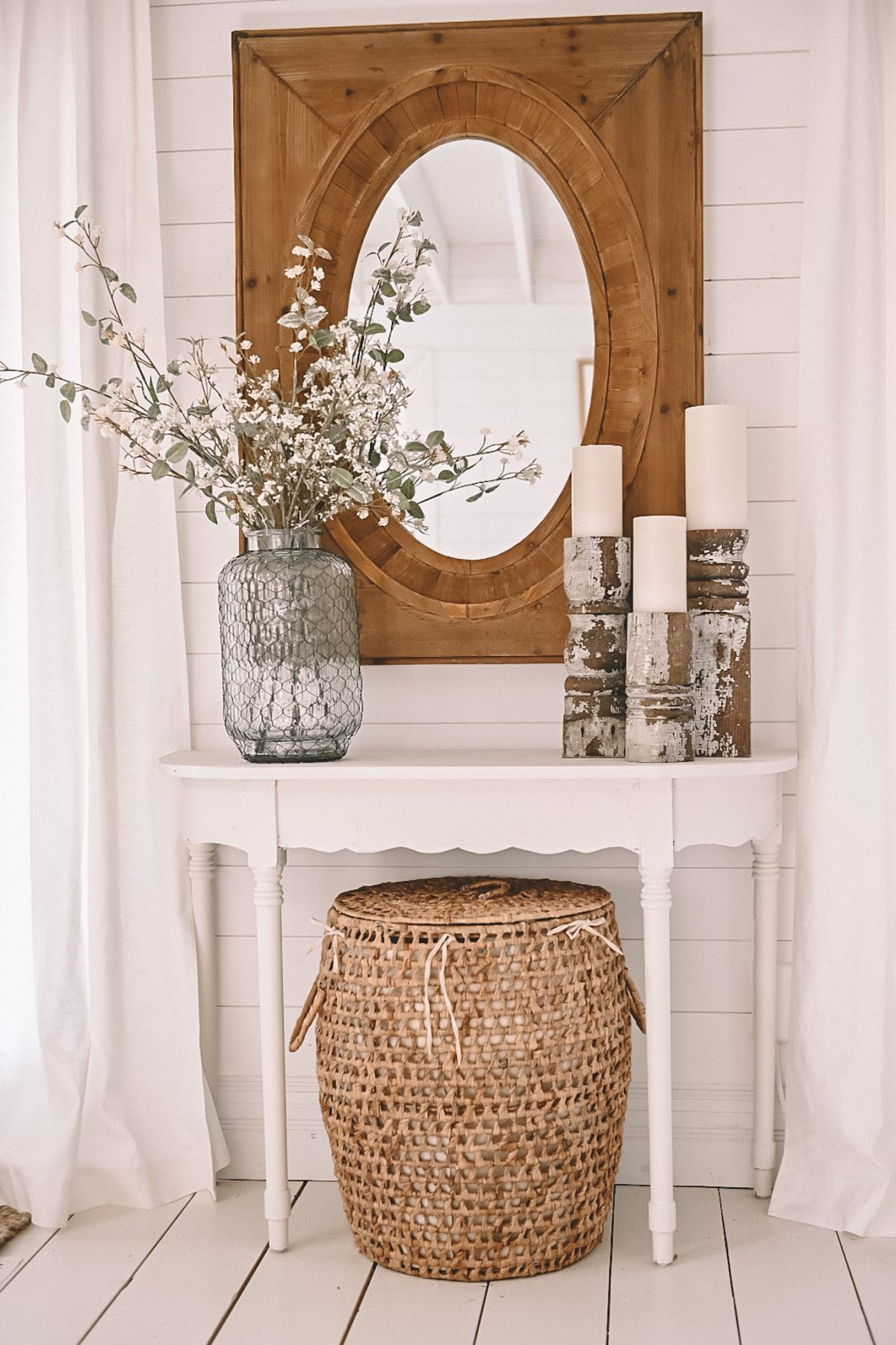 A wooden mirror hanging above an entryway table