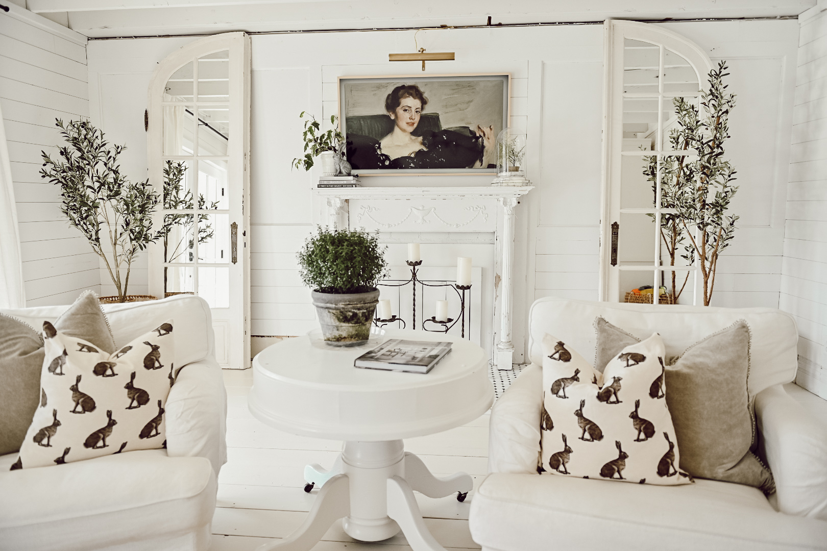 White Farmhouse Living room with Samsung Fire TV mounted about a white fireplace mantel