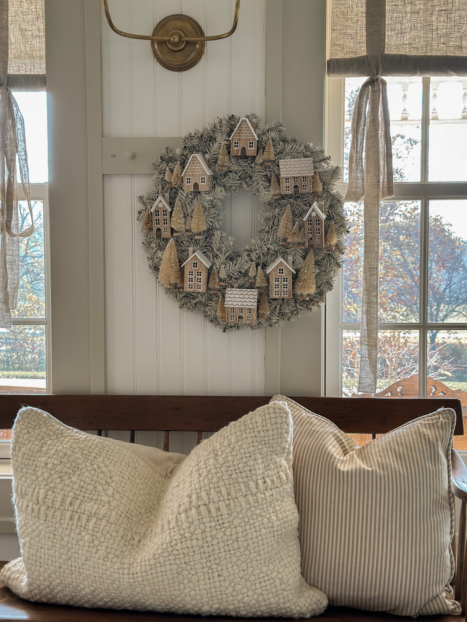 natural DIY Wreath with wooden houses and bottle brush trees