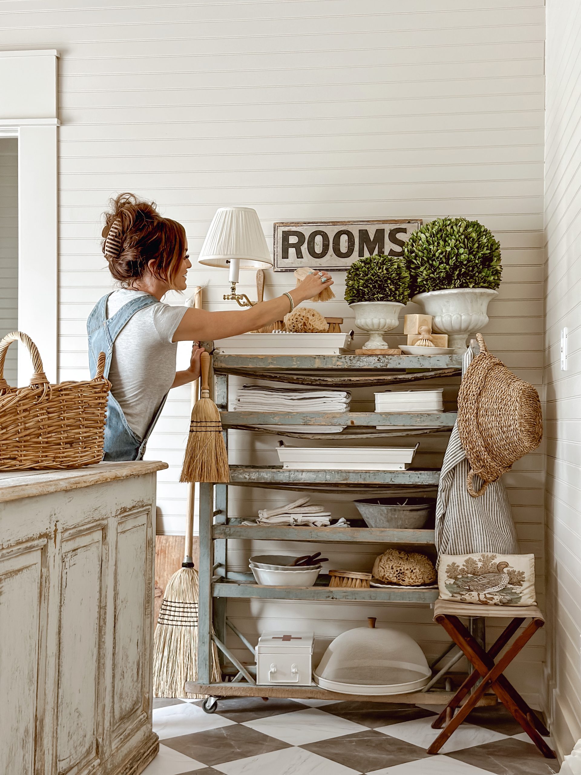 Liz Marie Galvan styling her antique rolling rack with a collection of vintage antiques and Walmart Hosting essentials by Better Homes and Gardens